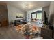 Comfortable living room with colorful rug, gray sofa and a view to the dining room with many windows at 3391 S Kirkman Rd # 1236, Orlando, FL 32811