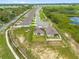 Aerial view of new construction home in a quiet neighborhood with a community pond at 3405 Yarian Dr, Haines City, FL 33844