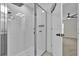 Bathroom with an all-glass shower featuring white tiling and chrome hardware at 3405 Yarian Dr, Haines City, FL 33844