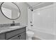 Bathroom featuring granite countertops, a round mirror, and a shower-tub combo at 3405 Yarian Dr, Haines City, FL 33844