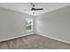 Neutral bedroom with a ceiling fan, one window, and carpeted flooring at 3405 Yarian Dr, Haines City, FL 33844