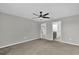 Carpeted bedroom with a ceiling fan and an open doorway to the attached bathroom at 3405 Yarian Dr, Haines City, FL 33844