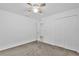 Neutral bedroom featuring a closet and doorway to another room with a ceiling fan at 3405 Yarian Dr, Haines City, FL 33844
