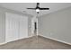 This bedroom features a ceiling fan, neutral walls, carpet, and closet at 3405 Yarian Dr, Haines City, FL 33844
