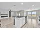 Open concept kitchen with a large island, stainless steel appliances, and sightlines to the living and dining areas at 3405 Yarian Dr, Haines City, FL 33844