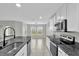 Bright, open kitchen with granite counters, stainless appliances, and a view into the dining area at 3405 Yarian Dr, Haines City, FL 33844