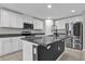 Modern kitchen with white cabinets, granite countertops, a center island, and stainless steel appliances at 3405 Yarian Dr, Haines City, FL 33844