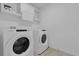 Laundry room featuring a Whirlpool washer and dryer and white cabinets above at 3405 Yarian Dr, Haines City, FL 33844