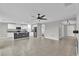 Spacious living room boasts tile flooring, an open layout, and a view into the kitchen at 3405 Yarian Dr, Haines City, FL 33844
