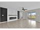 Open-concept living room with an electric fireplace, neutral walls, and sliding door access to the patio at 3405 Yarian Dr, Haines City, FL 33844