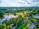 Overhead aerial view of a lush neighborhood with lake and golf course surrounded by green trees at 3460 Fairway Ln, Orlando, FL 32804