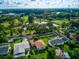 Aerial view showcasing the property, surrounding neighborhood, lush golf course, and a tranquil pond at 3460 Fairway Ln, Orlando, FL 32804