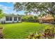 Expansive backyard with lush lawn, mature trees, a privacy fence, and an entertaining patio at 3460 Fairway Ln, Orlando, FL 32804