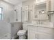 Bright bathroom with a walk-in shower, white subway tile, and a white vanity with a marble countertop at 3460 Fairway Ln, Orlando, FL 32804