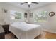 A light and bright bedroom with hardwood floors, two windows, and a ceiling fan at 3460 Fairway Ln, Orlando, FL 32804