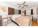 Cozy bedroom featuring a ceiling fan, bedside table, and neutral decor at 3460 Fairway Ln, Orlando, FL 32804