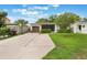 Cozy single-story home with a well-maintained lawn, brown garage door, and lush landscaping at 3460 Fairway Ln, Orlando, FL 32804