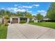 Charming single story home featuring a brown garage door, manicured lawn and lush green shrubbery at 3460 Fairway Ln, Orlando, FL 32804