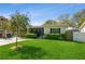 Well-maintained home featuring a vibrant green lawn and mature bottlebrush tree at 3460 Fairway Ln, Orlando, FL 32804