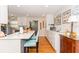 Open concept kitchen with breakfast bar, white cabinets, and hardwood floors at 3460 Fairway Ln, Orlando, FL 32804