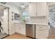 Bright kitchen featuring stainless steel appliances, white cabinets, and hardwood floors at 3460 Fairway Ln, Orlando, FL 32804