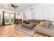Cozy living room with a ceiling fan, neutral colors, stylish furniture, and access to the outdoor space at 3460 Fairway Ln, Orlando, FL 32804
