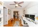 Bright office with hardwood floors, ceiling fan, and a view into the kitchen at 3460 Fairway Ln, Orlando, FL 32804