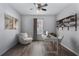 Cozy office with a ceiling fan, modern furniture, hardwood floors, and natural lighting at 356 Nova Dr, Davenport, FL 33837