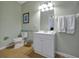Well-lit bathroom with a single vanity, toilet, and tiled floors at 4816 Tidecrest Ave # 178, Orlando, FL 32819