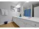 Bright bathroom featuring a double sink vanity, large mirror and neutral wall color at 4816 Tidecrest Ave # 178, Orlando, FL 32819