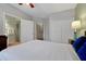 Comfortable bedroom featuring a ceiling fan, closet, and an ensuite bathroom at 4816 Tidecrest Ave # 178, Orlando, FL 32819