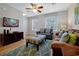 Cozy living room featuring modern decor, a flat-screen TV, and comfortable seating arrangements at 4816 Tidecrest Ave # 178, Orlando, FL 32819