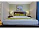 Comfortable main bedroom featuring soft lighting, a plush bed, and stylish accents at 4816 Tidecrest Ave # 178, Orlando, FL 32819