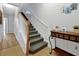 Carpeted staircase with white wood trim and a decorative table at 4816 Tidecrest Ave # 178, Orlando, FL 32819