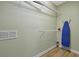 Walk-in closet with shelving, hanging racks, iron and ironing board at 4816 Tidecrest Ave # 178, Orlando, FL 32819