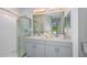 Bathroom with double vanity sinks, framed mirrors, a shower, and plenty of counter space at 483 Wayland Dr, Haines City, FL 33844