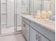 Modern bathroom with double vanity, sleek cabinets, quartz countertops, and glass-enclosed shower at 483 Wayland Dr, Haines City, FL 33844