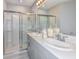 Well-lit bathroom boasts double sinks, quartz countertop, shower, and modern fixtures at 483 Wayland Dr, Haines City, FL 33844