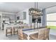 Bright dining area features modern lighting, seating for six, and an adjacent kitchen with stainless steel appliances at 483 Wayland Dr, Haines City, FL 33844