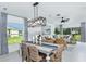 Bright dining area with stylish chandelier, modern decor, and views of the outdoors at 483 Wayland Dr, Haines City, FL 33844