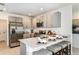 Modern kitchen with stainless steel appliances, gray cabinets, and a breakfast bar with seating at 483 Wayland Dr, Haines City, FL 33844