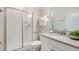 Bright bathroom featuring a glass-enclosed shower and a stylish white vanity with grey countertop at 4834 Lullaby Ln, Kissimmee, FL 34746