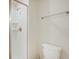 Bright bathroom with white toilet and shower featuring glass door at 4834 Lullaby Ln, Kissimmee, FL 34746