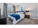 Comfortable bedroom with a queen-sized bed, cool-toned art, and plenty of natural light at 4834 Lullaby Ln, Kissimmee, FL 34746