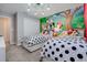 Charming themed bedroom with two beds and delightful mural on the back wall at 4834 Lullaby Ln, Kissimmee, FL 34746