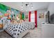 Themed ' bedroom with twin beds, cartoon wall art, and whimsical decor at 4834 Lullaby Ln, Kissimmee, FL 34746