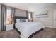 Serene bedroom featuring a gray upholstered bed, modern decor, and plenty of natural light at 4834 Lullaby Ln, Kissimmee, FL 34746