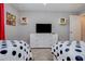 Bright bedroom with two polka dot beds, entertainment center, and themed decor at 4834 Lullaby Ln, Kissimmee, FL 34746