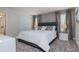 Elegant bedroom with a gray upholstered bed, soft lighting, and a view of the en-suite bathroom at 4834 Lullaby Ln, Kissimmee, FL 34746
