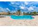 Large community pool with a tropical theme and plenty of lounge chairs at 4834 Lullaby Ln, Kissimmee, FL 34746